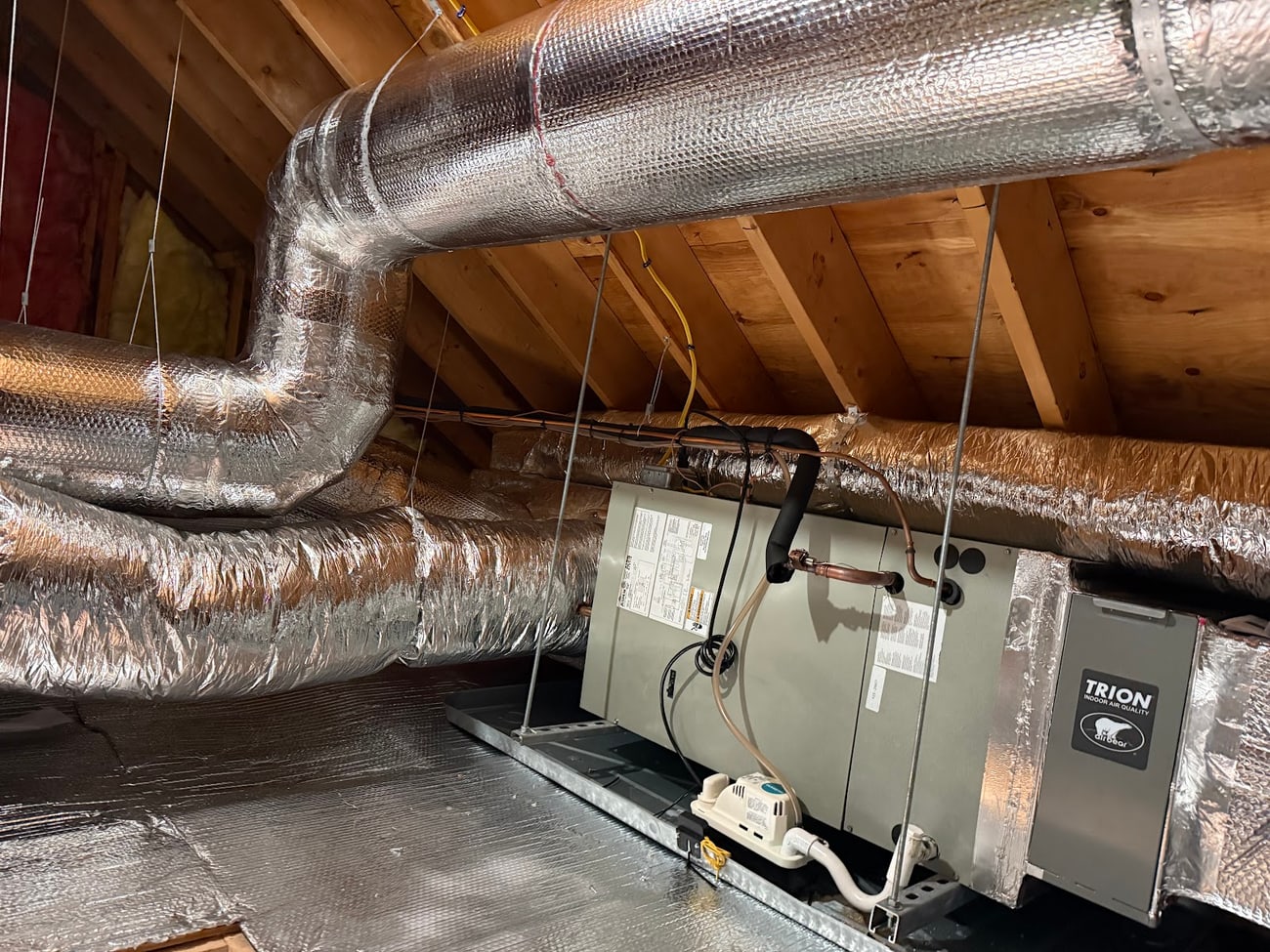 Attic air handler with Trion Air Bear filtration and insulated supply ductwork installed by Harbormen Heating and Cooling